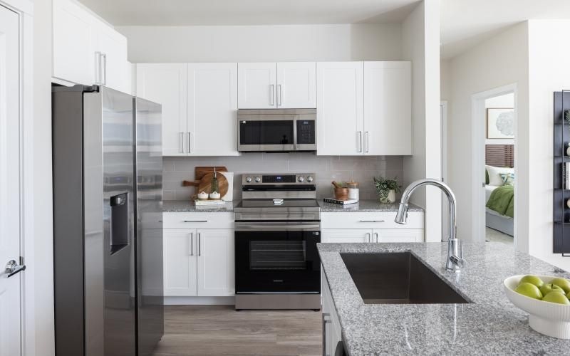 a kitchen with white cabinets