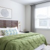 bedroom with a large window and modern decor