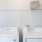 a white washing machine and a white laundry basket