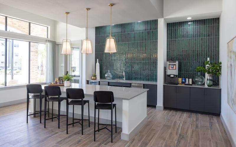 a kitchen with a bar and chairs