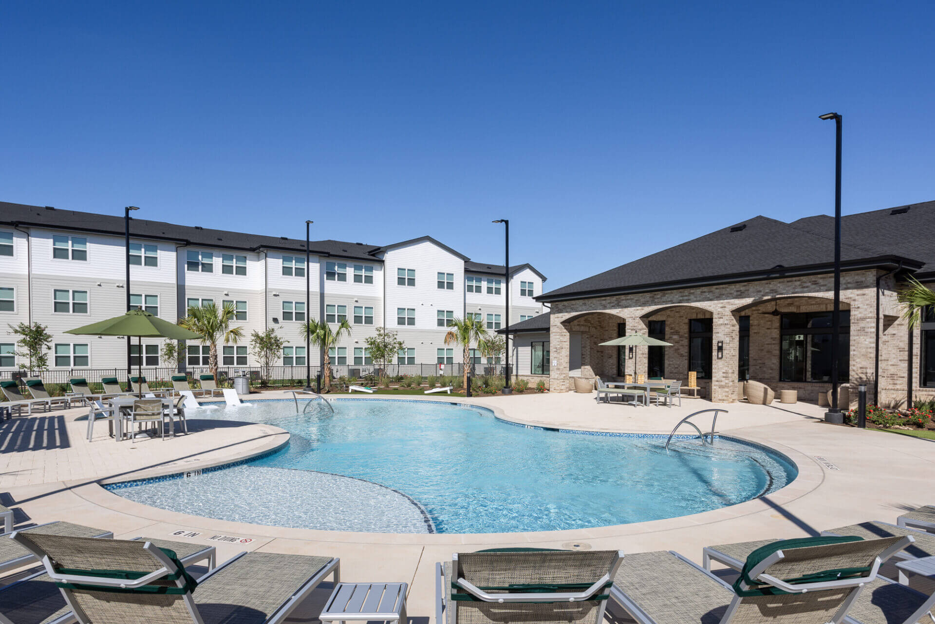 Swimming pool surrounded by lounge chairs at prose thunder rock in marble falls, tx