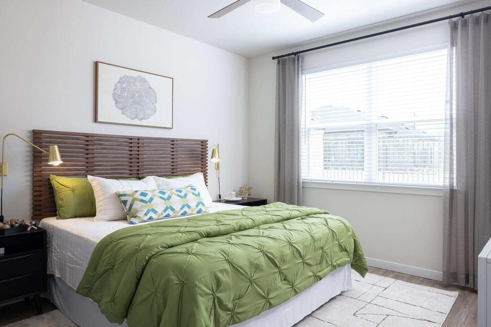 Bed in bedroom with brown headboard and large, bright window in background in marble falls, tx